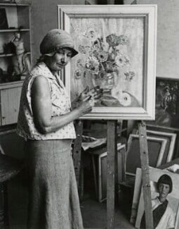 Photograph of Gertrude Harvey painting in her studio